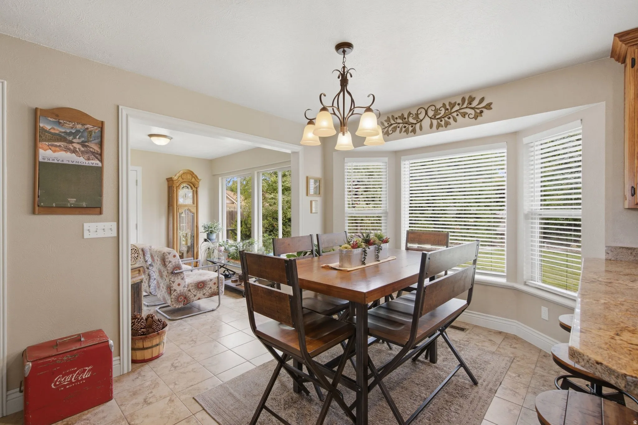 Dining area featuring a bay window with multiple panes, recessed lighting, and a decorative chandelier