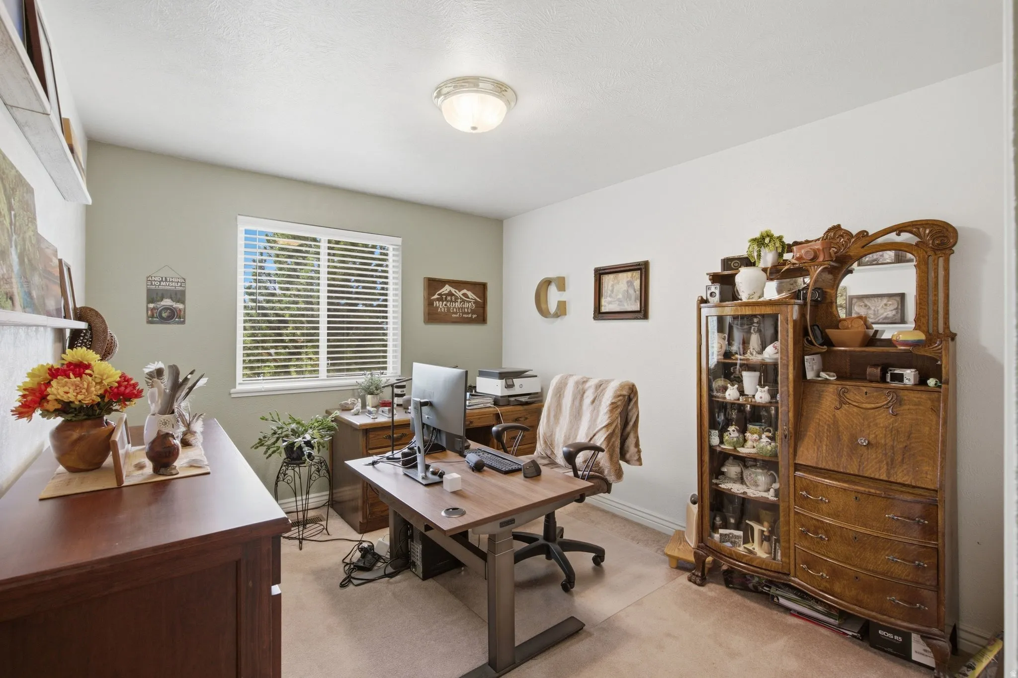 Interior room featuring a large window with horizontal blinds, light-toned walls, and a semi-flush mount ceiling light