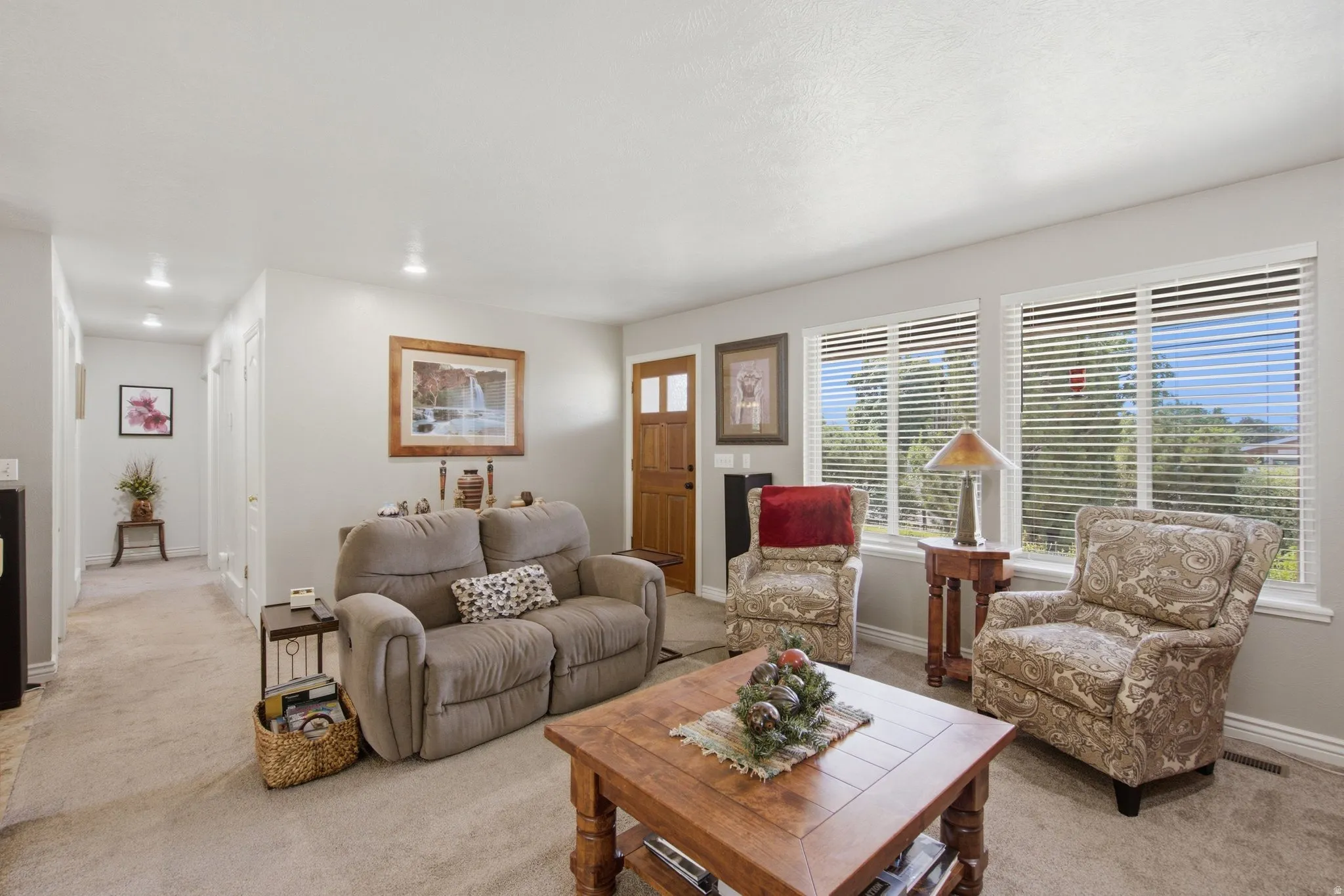 Living area featuring light gray wall paint and recessed lighting