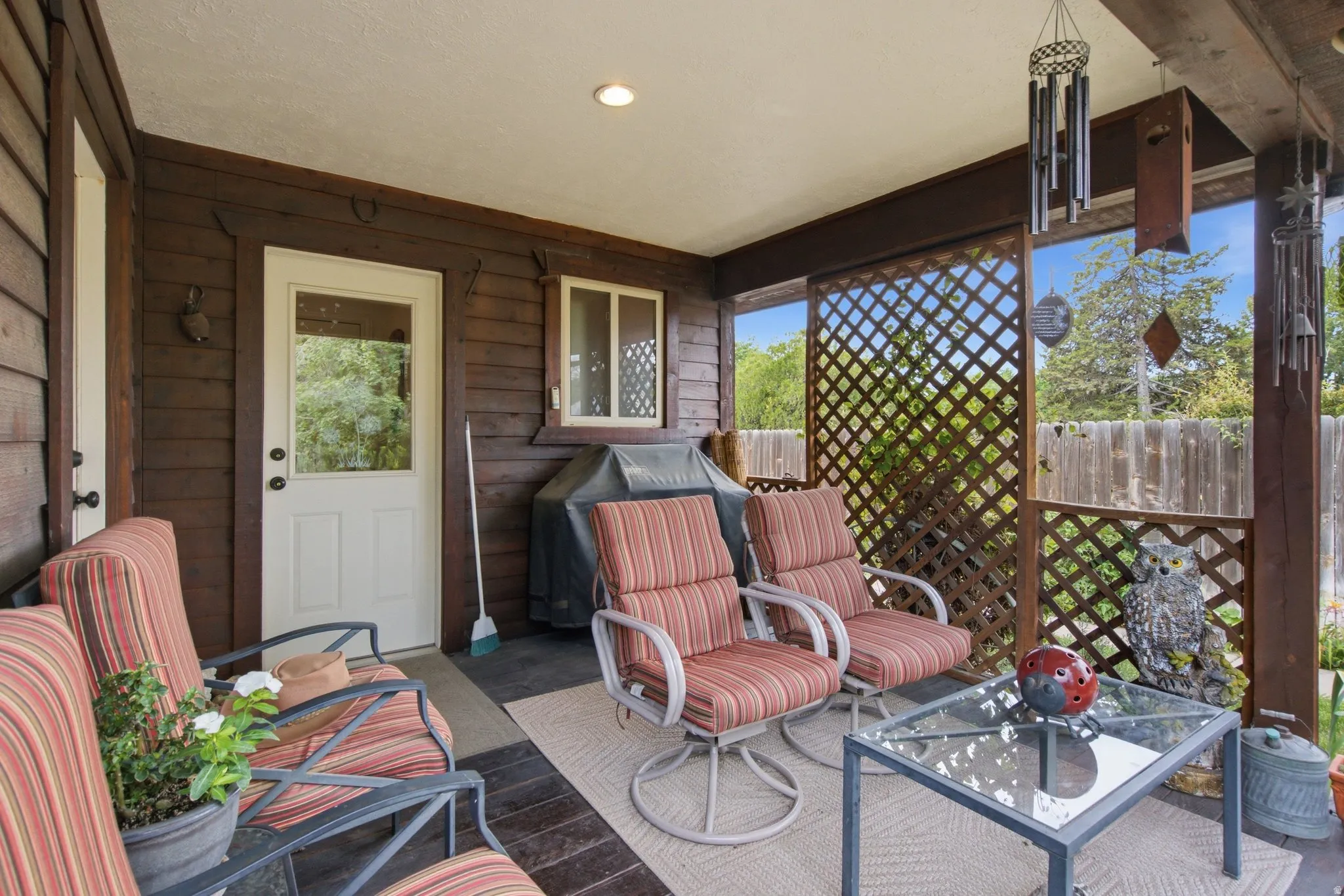 Covered deck featuring wood-finish siding, a latticework screen, and recessed lighting