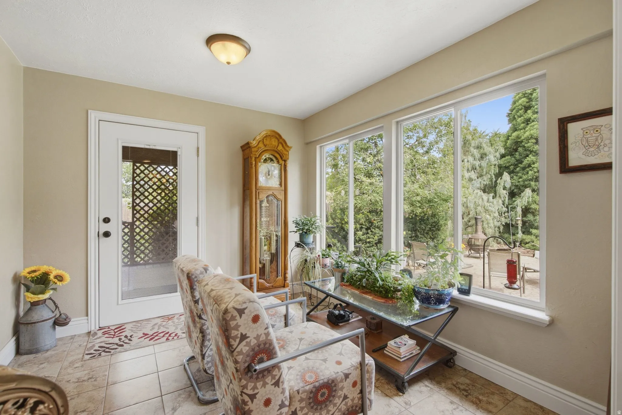 Bright interior space featuring multiple large windows and a glass-paneled door