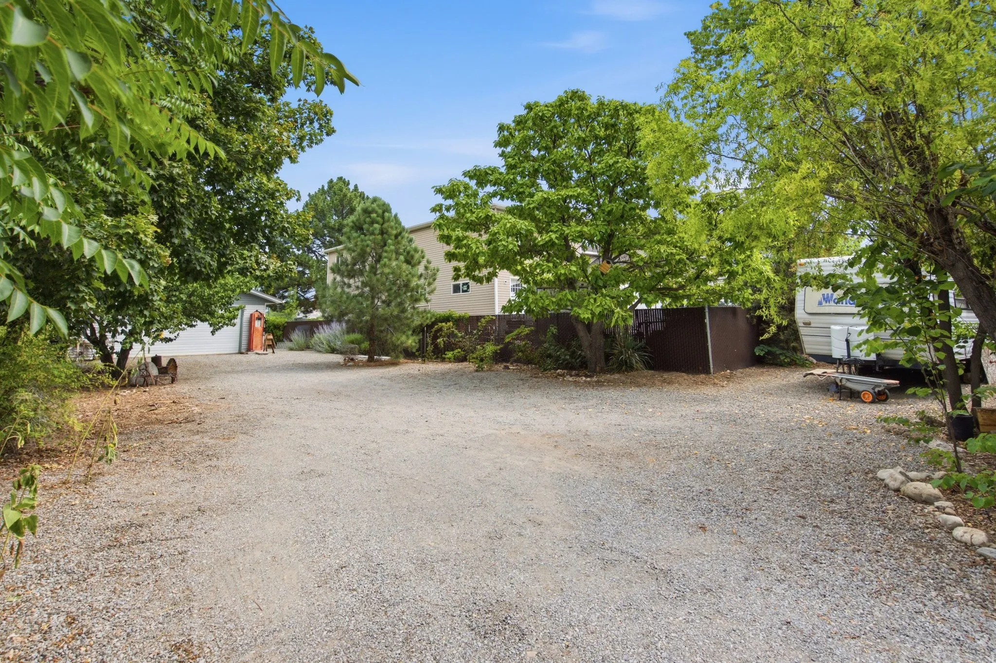 Expansive gravel driveway providing ample parking