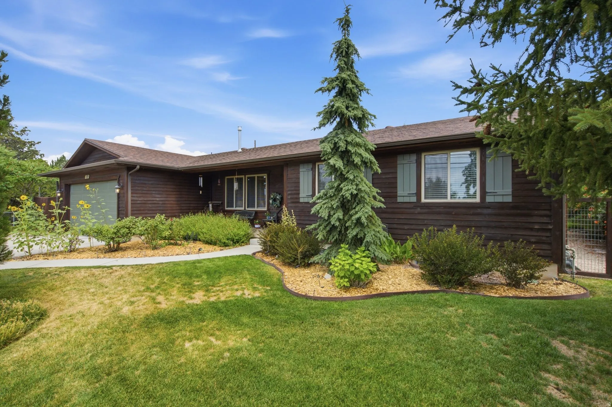 Brown horizontal siding exterior with a light brown shingle roof