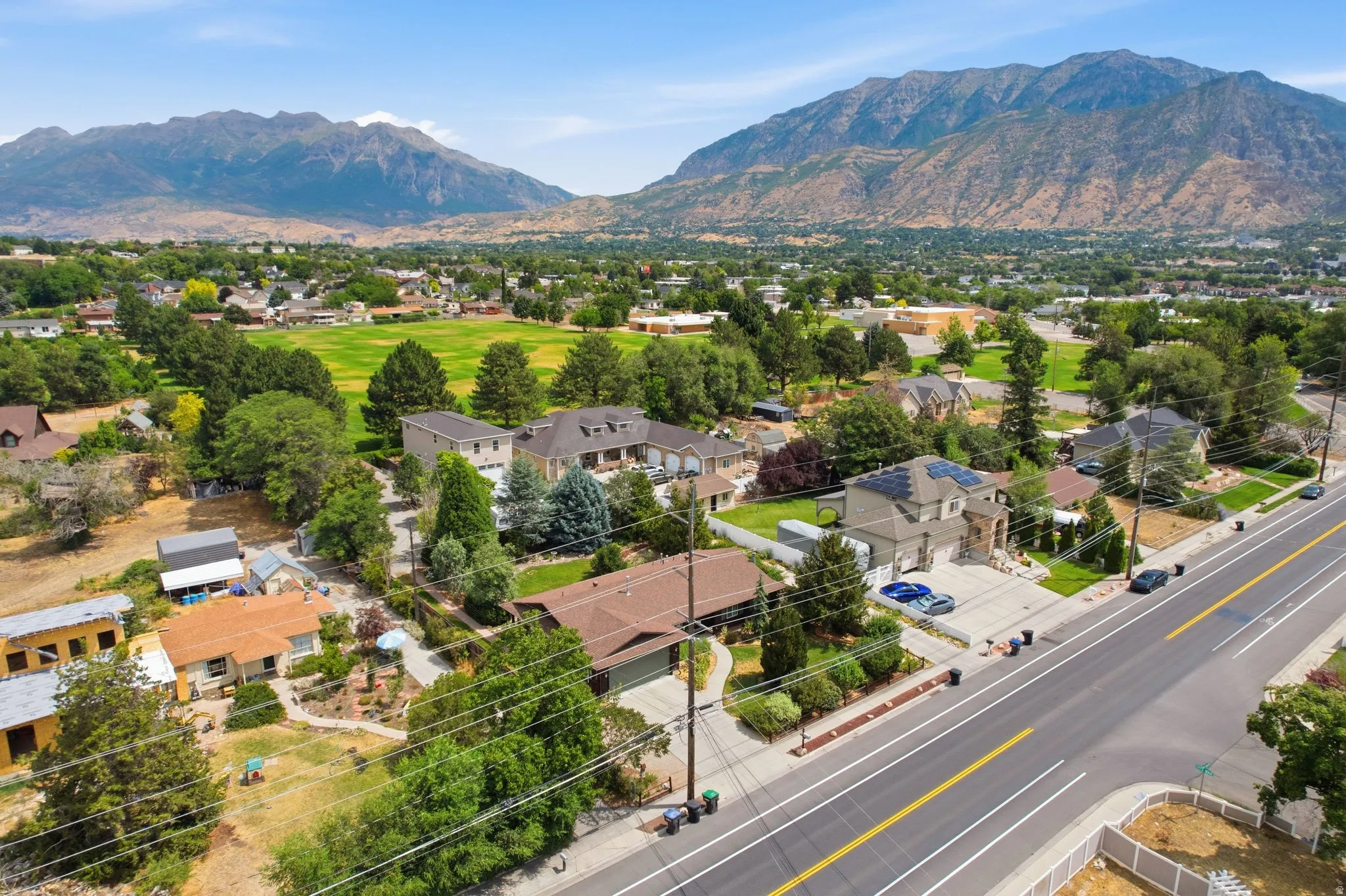 Overhead view of a suburban neighborhood featuring residential properties and a mountain backdrop