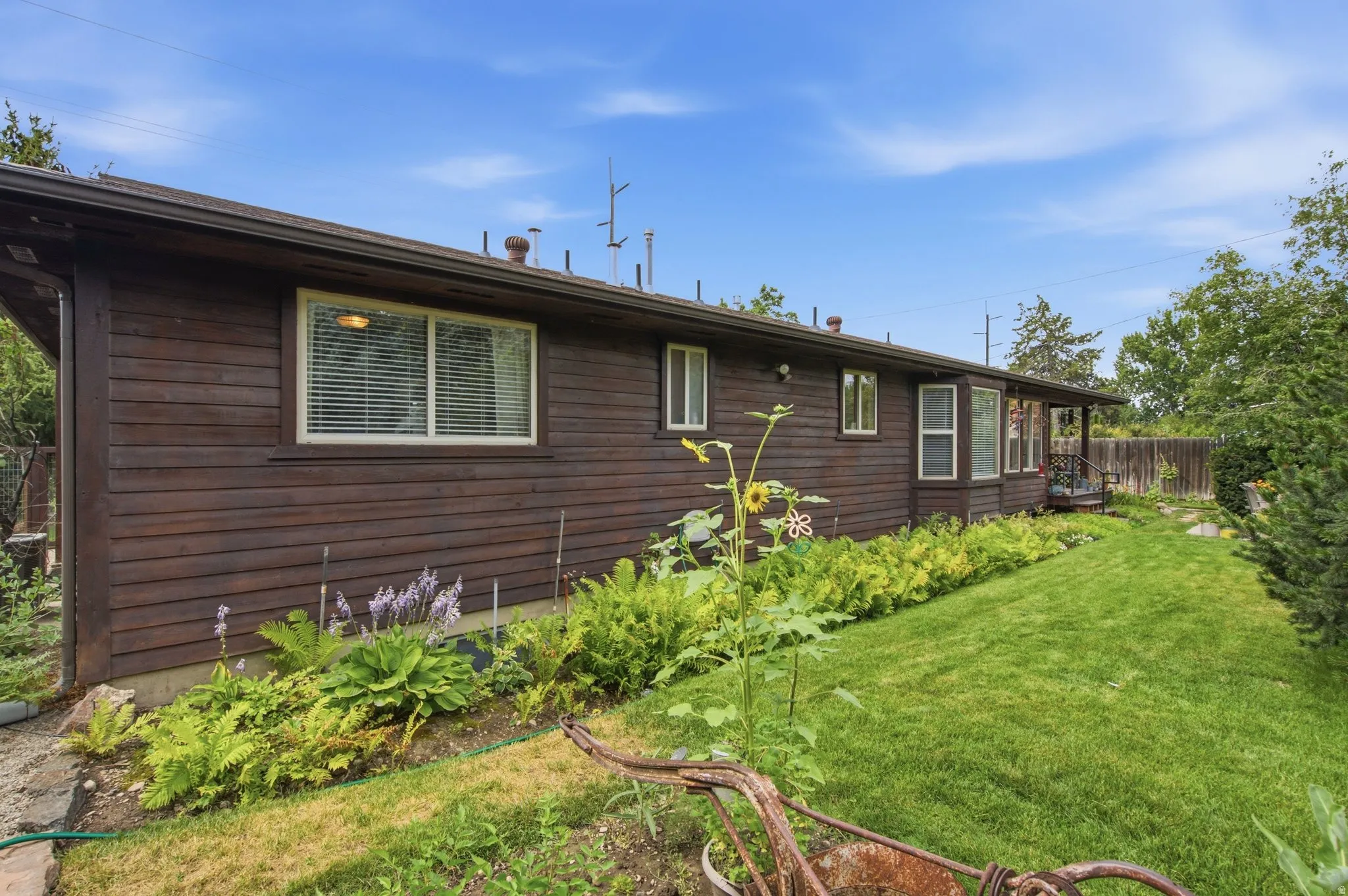 Wood-clad exterior with multiple windows and a bay window feature