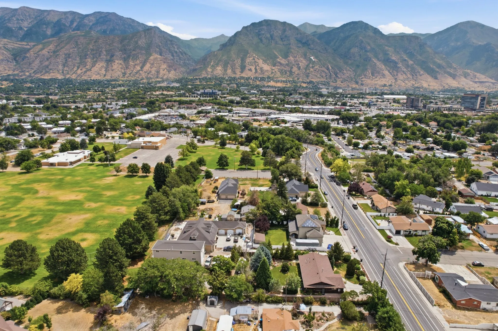 Expansive mountain backdrop framing a verdant urban landscape