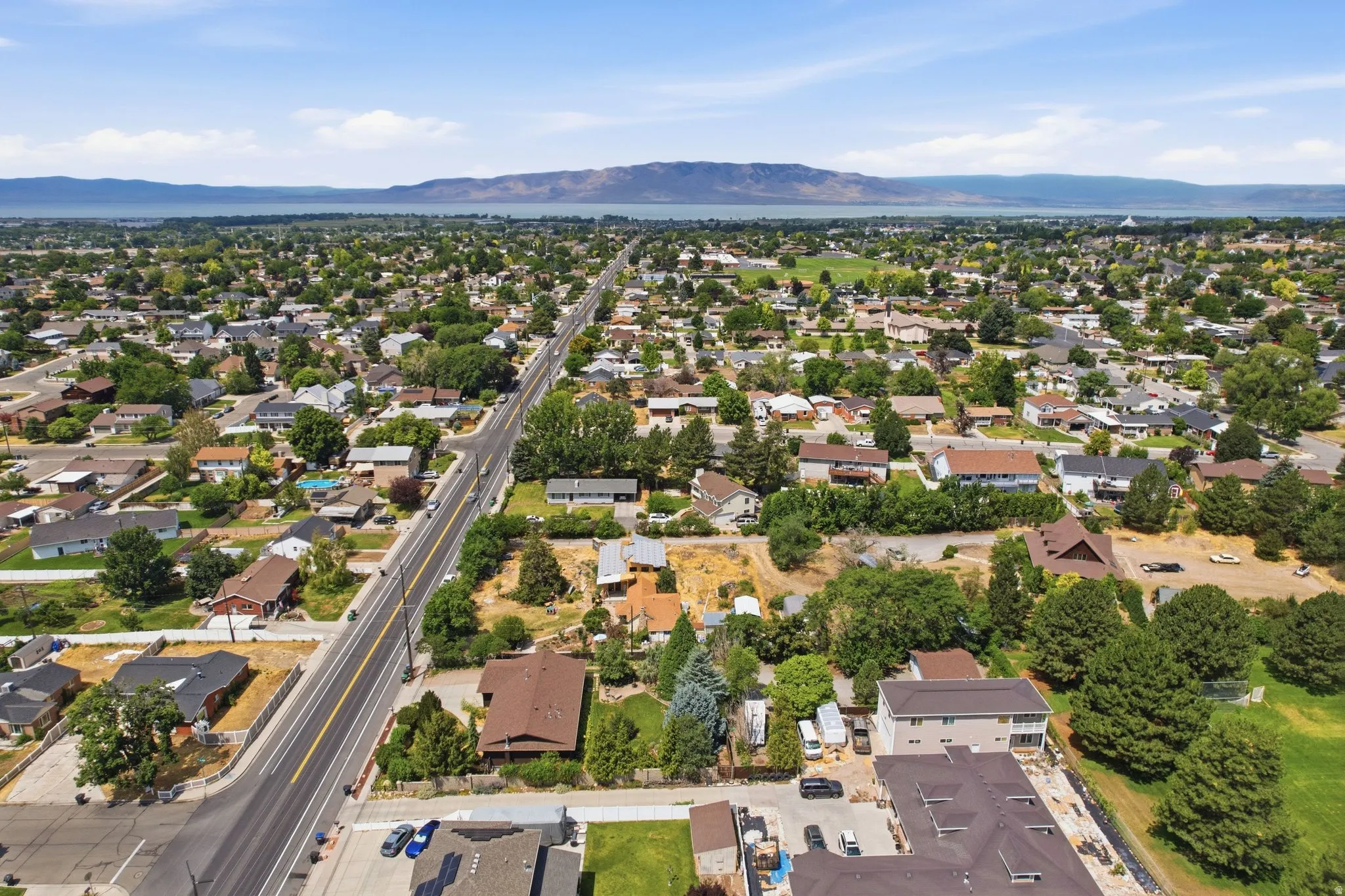 Expansive aerial perspective showcasing a residential area with a prominent roadway