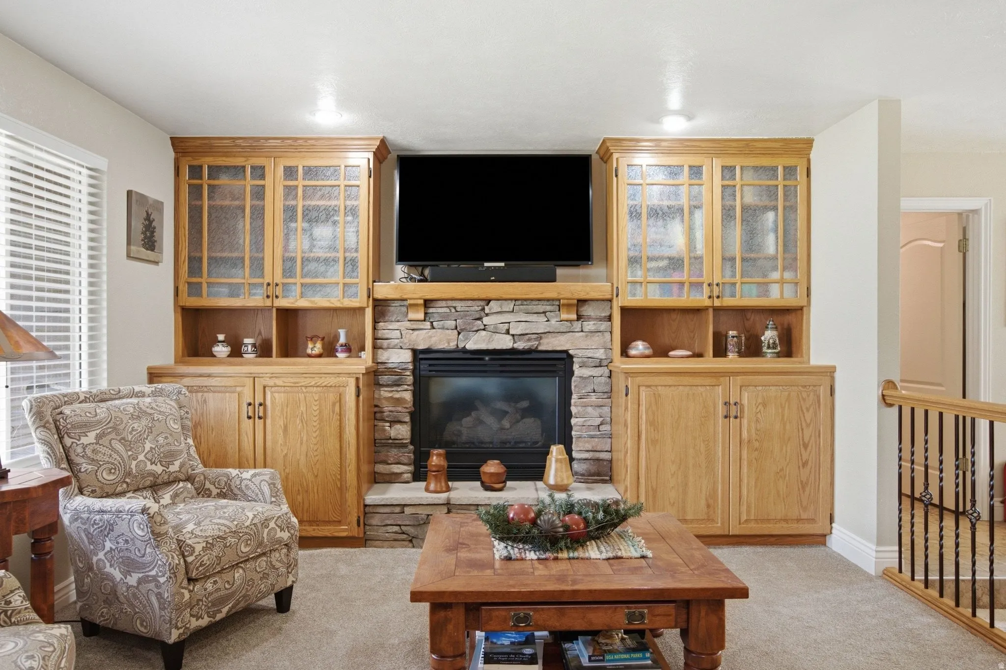 Central stone-surround fireplace with a wood mantelpiece