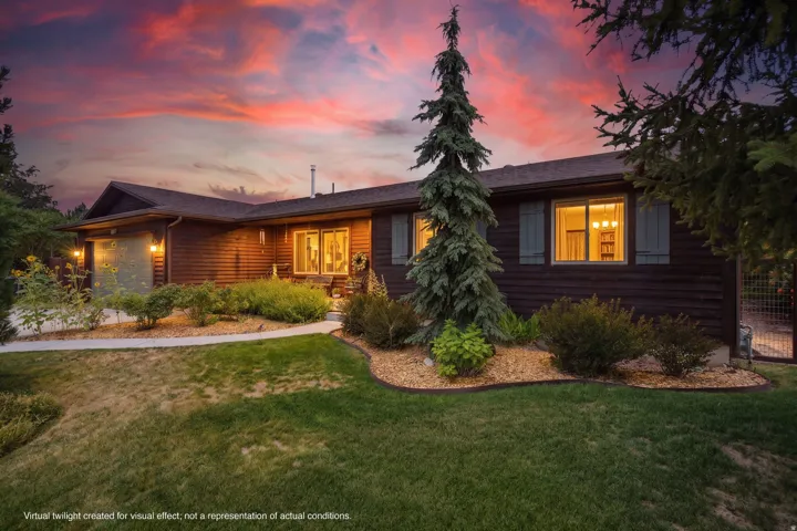 Single-story wood-sided residence featuring a landscaped front yard with mature plantings