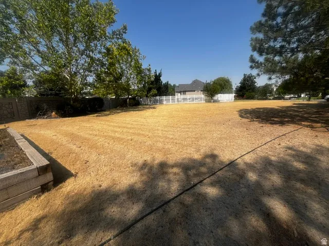 Expansive outdoor space featuring a large, level lawn area