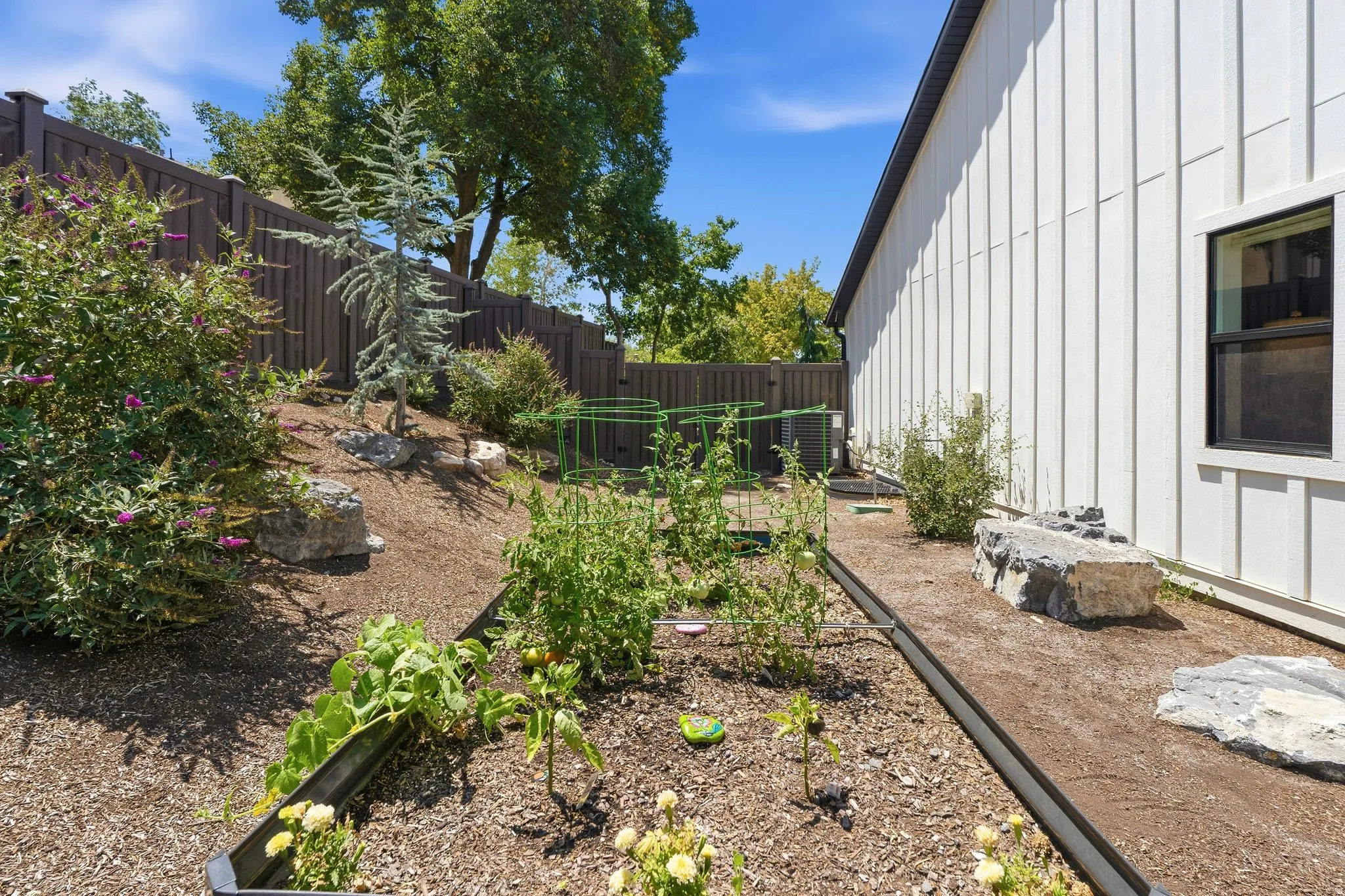 Garden area featuring a raised garden bed, and a privacy fence