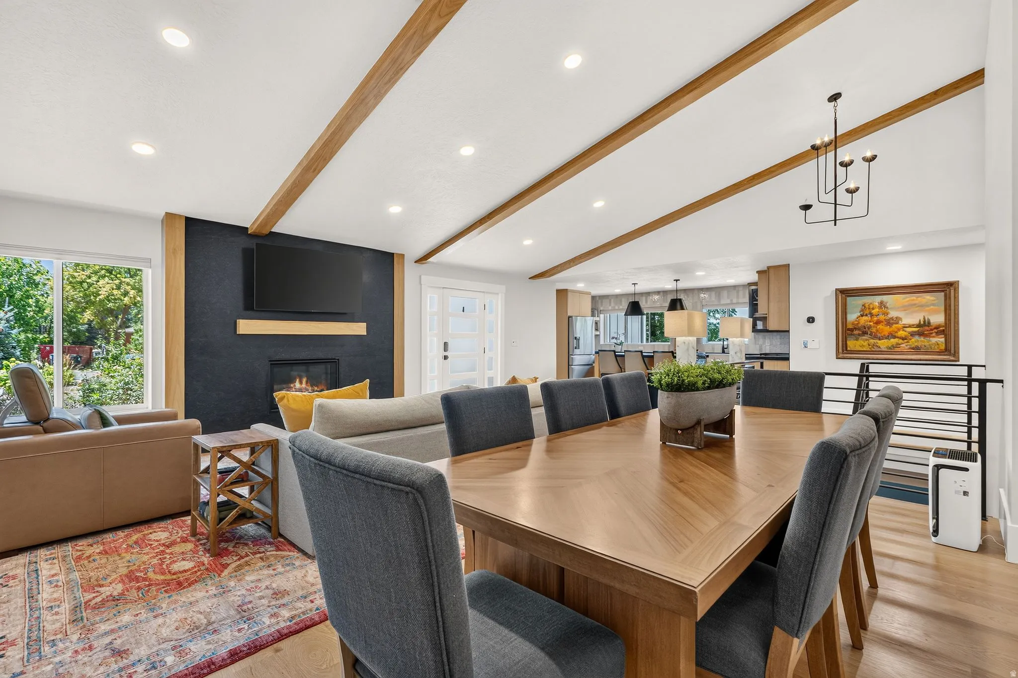 Vaulted ceilings with exposed wood beams define this open-concept living space