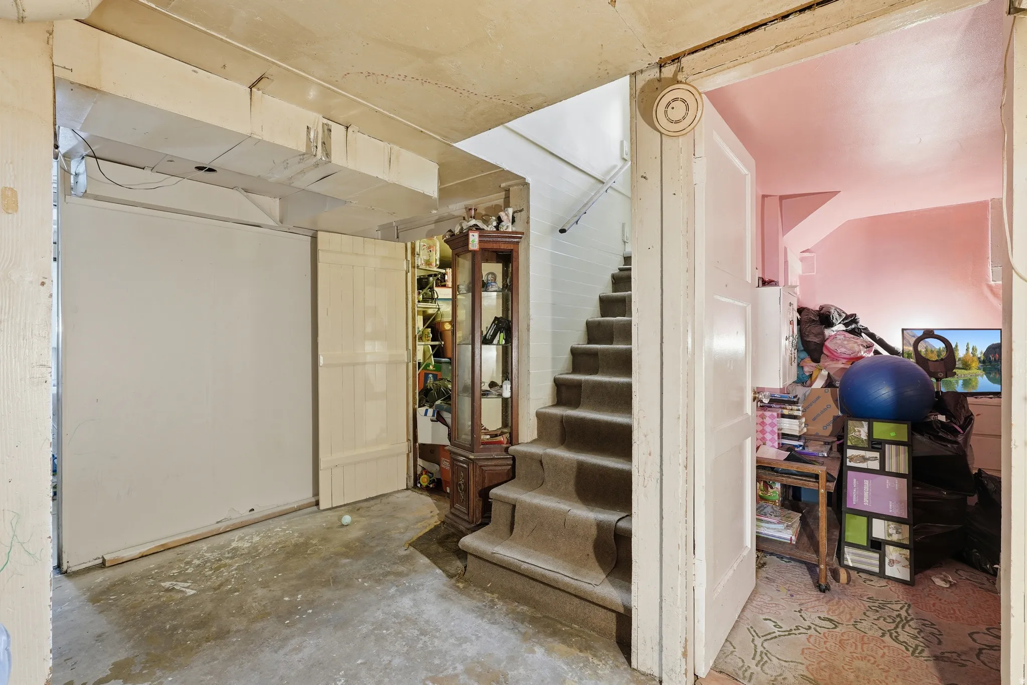 Carpeted staircase with painted risers and handrail