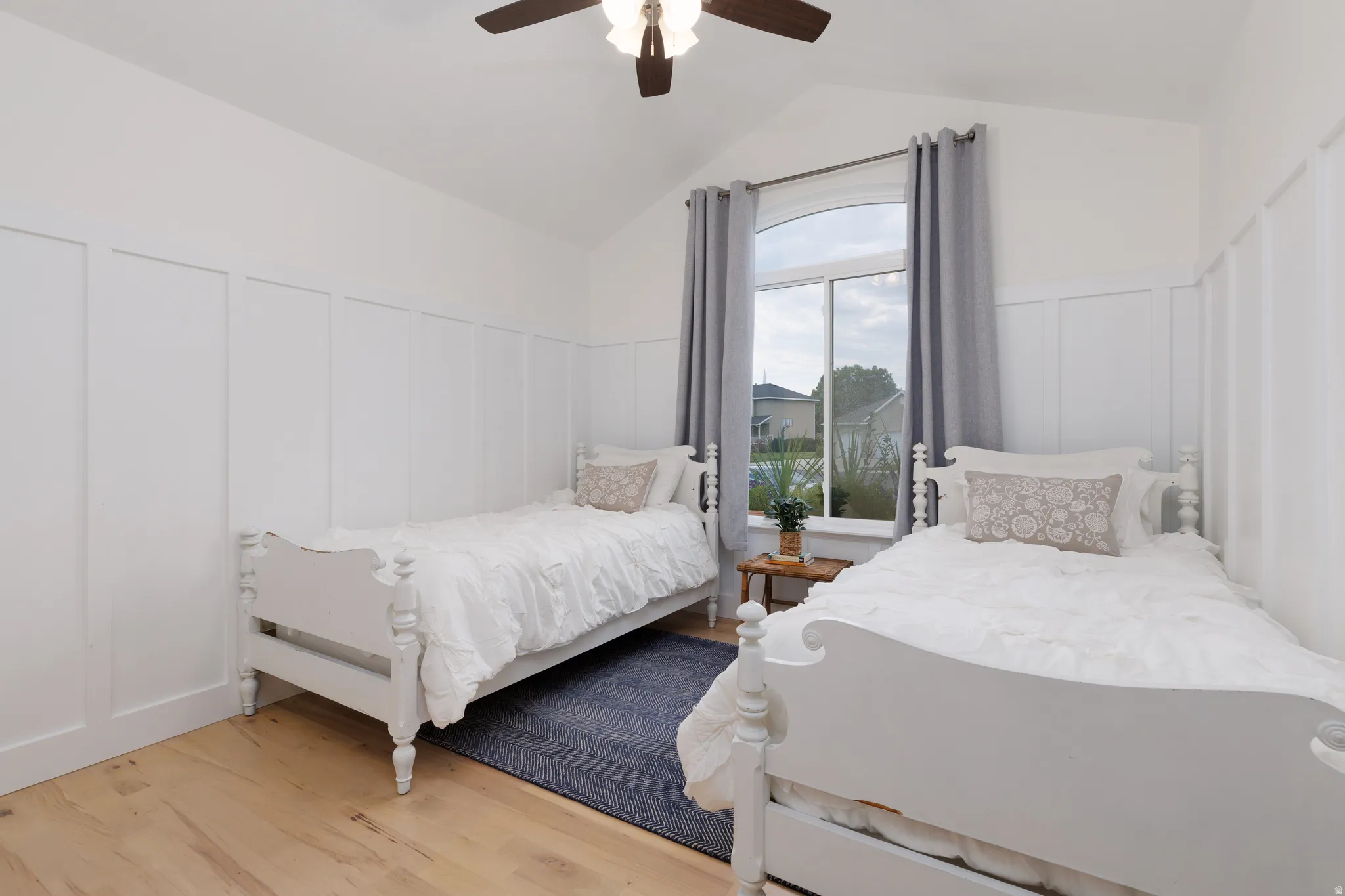 Vaulted ceiling room featuring board and batten wall detailing
