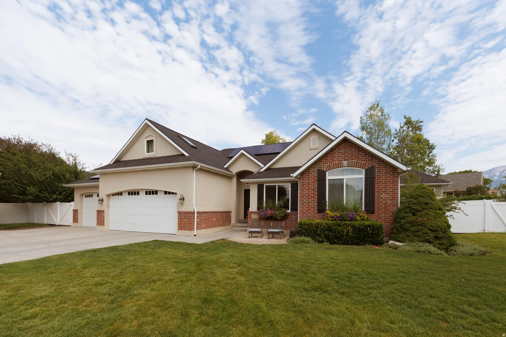 Stucco and brick exterior with a multi-car garage