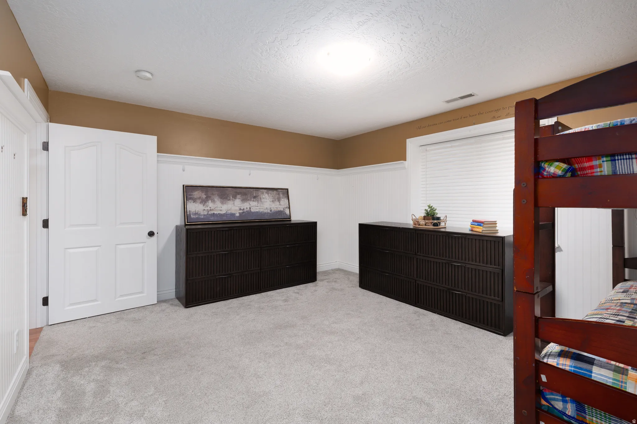Neutral tone walls with white wainscoting and trim