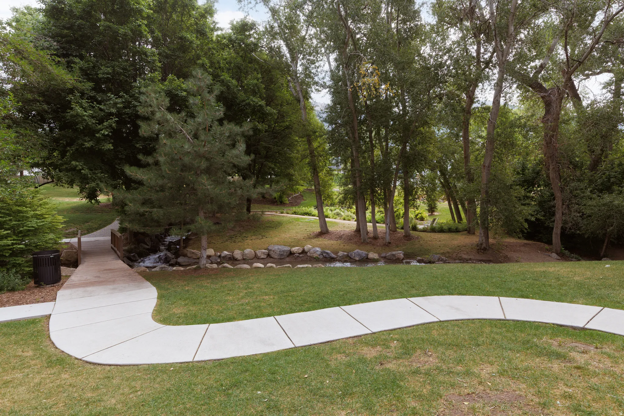 Manicured green spaces with a winding concrete pathway
