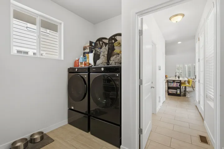 Dedicated utility space featuring a window, light gray wall paint, and tile flooring