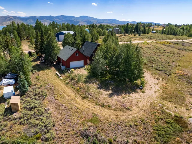 Back of Cabin/Garage - surrounded by mature trees & has a great view of the lake from the back!