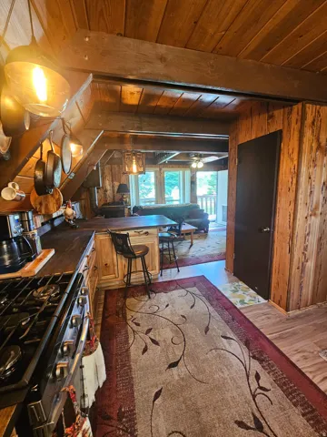 Rustic updated kitchen featuring newer stainless steel gas range & fridge! Newer countertops & cabinets!