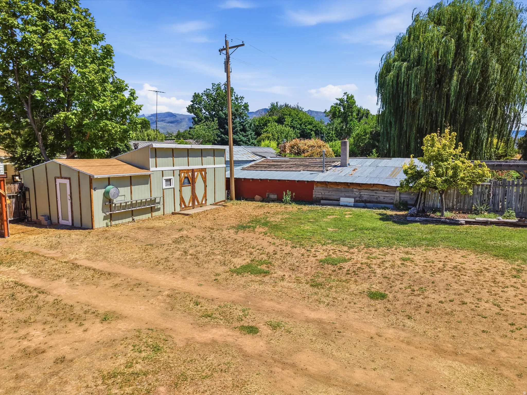 Expansive outdoor area featuring a combination of natural ground and partial lawn