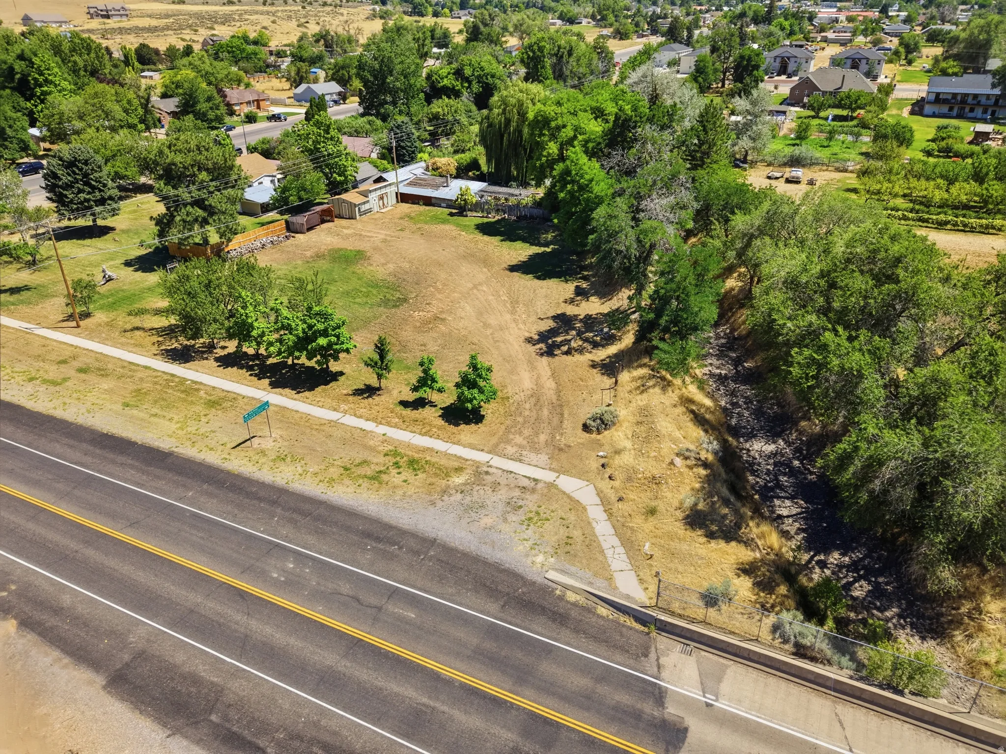 Expansive undeveloped lot featuring mature trees and established street frontage