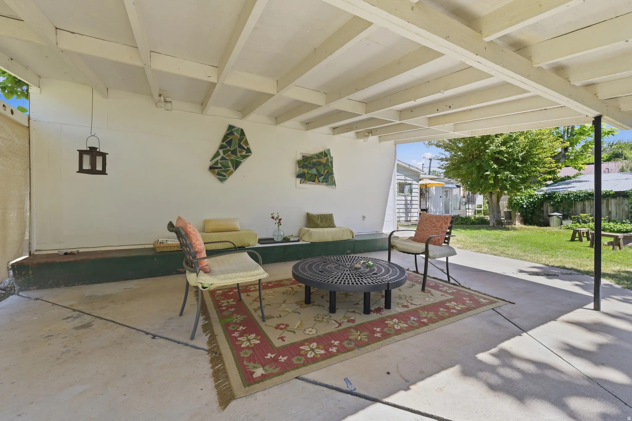 Covered patio featuring a concrete slab and exposed beam ceiling