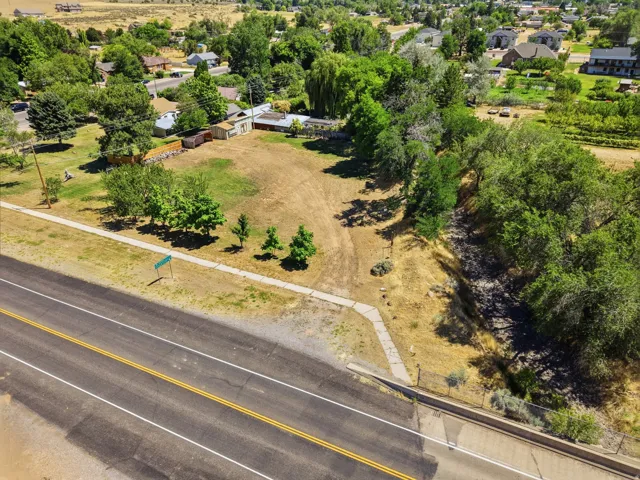 Expansive undeveloped lot featuring mature trees and established street frontage