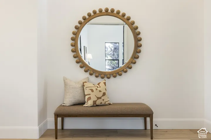 Warm wood-finish flooring complements crisp white walls and baseboards