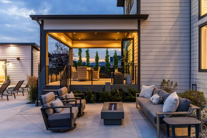 Expansive concrete patio featuring a built-in fire pit