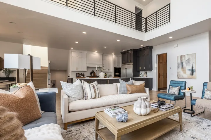 Open-concept living area featuring high ceilings, recessed lighting, and wood-finish flooring