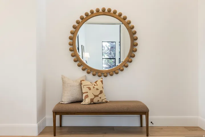 Warm wood-finish flooring complements crisp white walls and baseboards