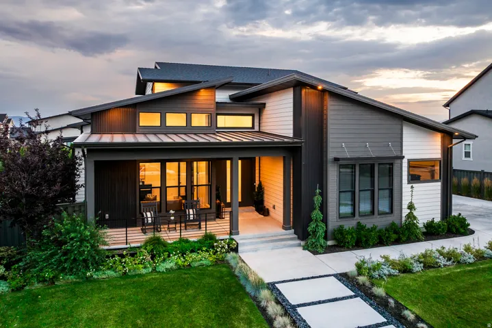 Contemporary exterior with a covered front porch, an angled roofline, and varied siding textures