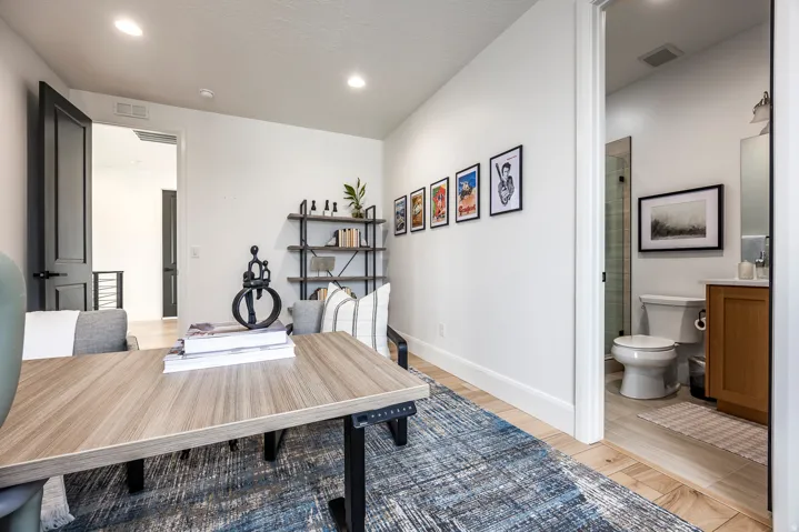 Bright room featuring wood-finish flooring and recessed lighting