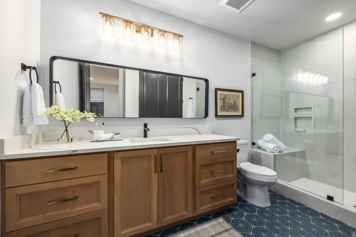 Bathroom featuring a natural wood-finish vanity with a white countertop and rectangular sink