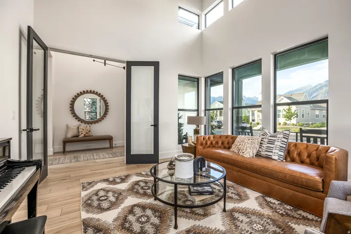 Living space with high ceilings and light wood-finish flooring