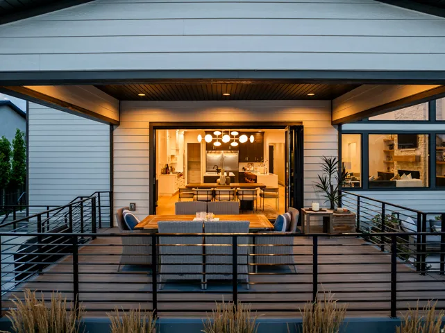 Expansive outdoor deck featuring wood-finish flooring and black metal railings