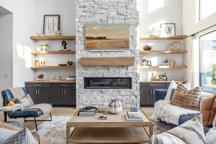 Floor-to-ceiling stone-faced fireplace with a linear insert and a wood mantel