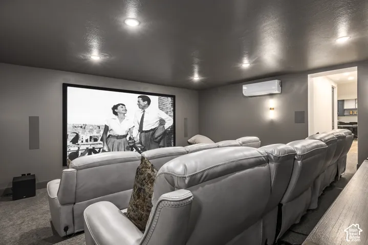 Dedicated media room featuring a large projection screen and built-in speakers