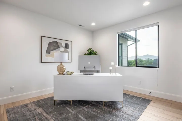 Bright interior space featuring a large window with mountain scenery