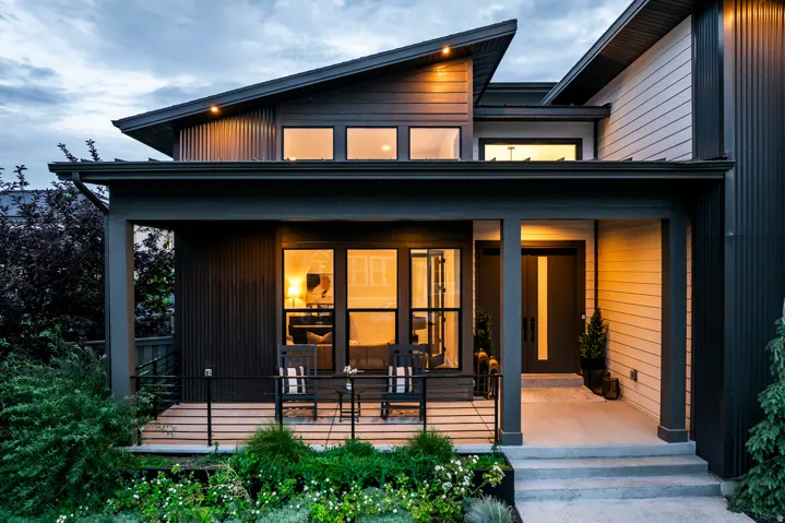 Contemporary architectural design featuring a prominent angled roofline and dark corrugated metal siding