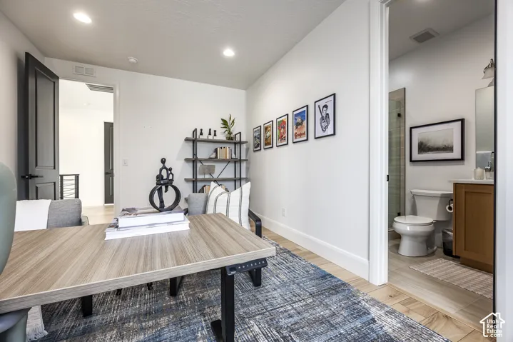 Bright room featuring wood-finish flooring and recessed lighting