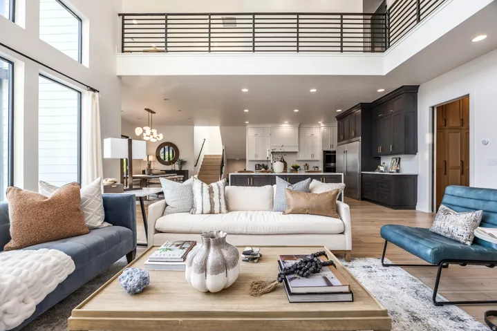 Open concept living area featuring a two-story ceiling and abundant natural light from large windows