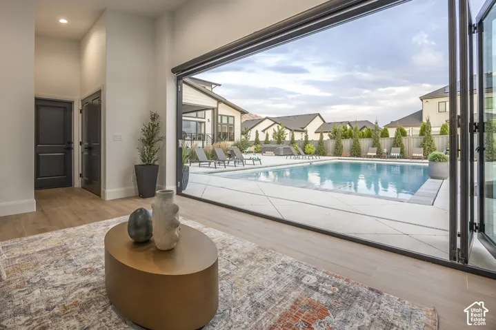 Expansive outdoor space featuring a large swimming pool with surrounding concrete patio