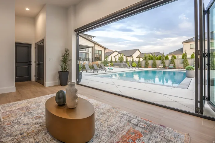 Expansive outdoor space featuring a large swimming pool with surrounding concrete patio