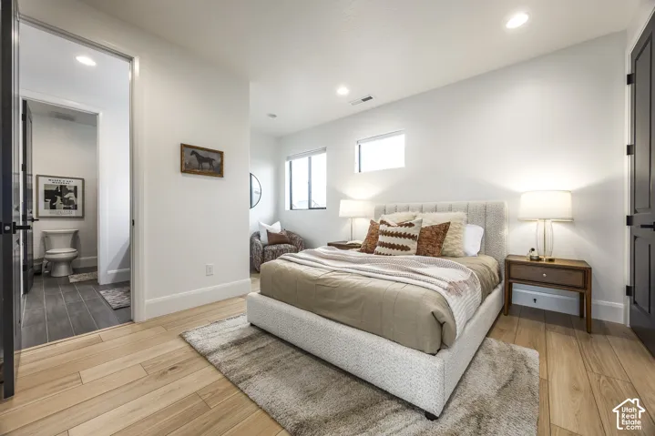 Light wood-finish flooring throughout the room and into the entryway
