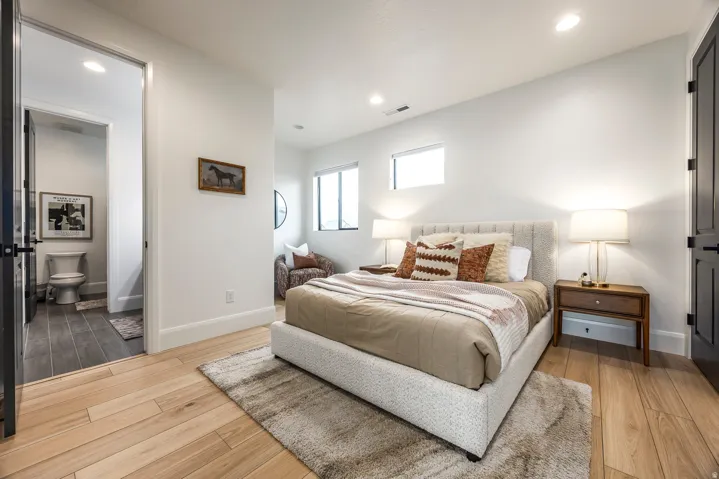 Light wood-finish flooring throughout the room and into the entryway