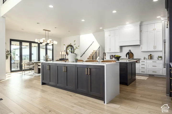 Open-concept kitchen with light wood-finish flooring