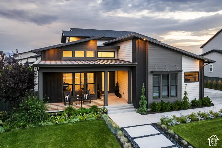 Contemporary exterior with a covered front porch, an angled roofline, and varied siding textures