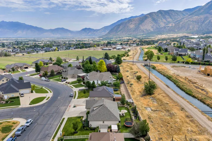 Residential community featuring mountain backdrops and a visible irrigation canal